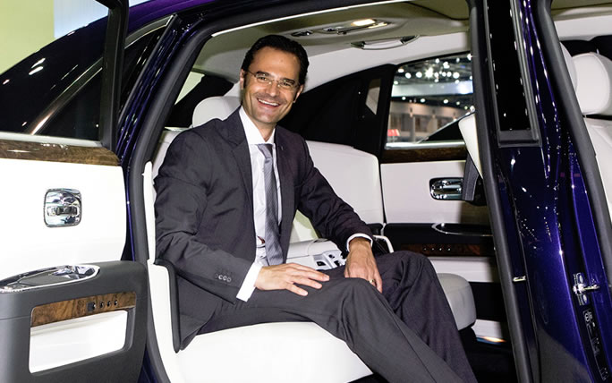 ceo in a chauffeur-driven limousine
