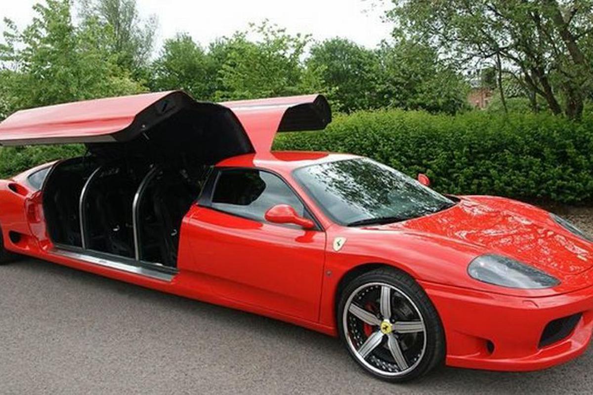 Red Ferrai limo side view of seating under open gullwing doors